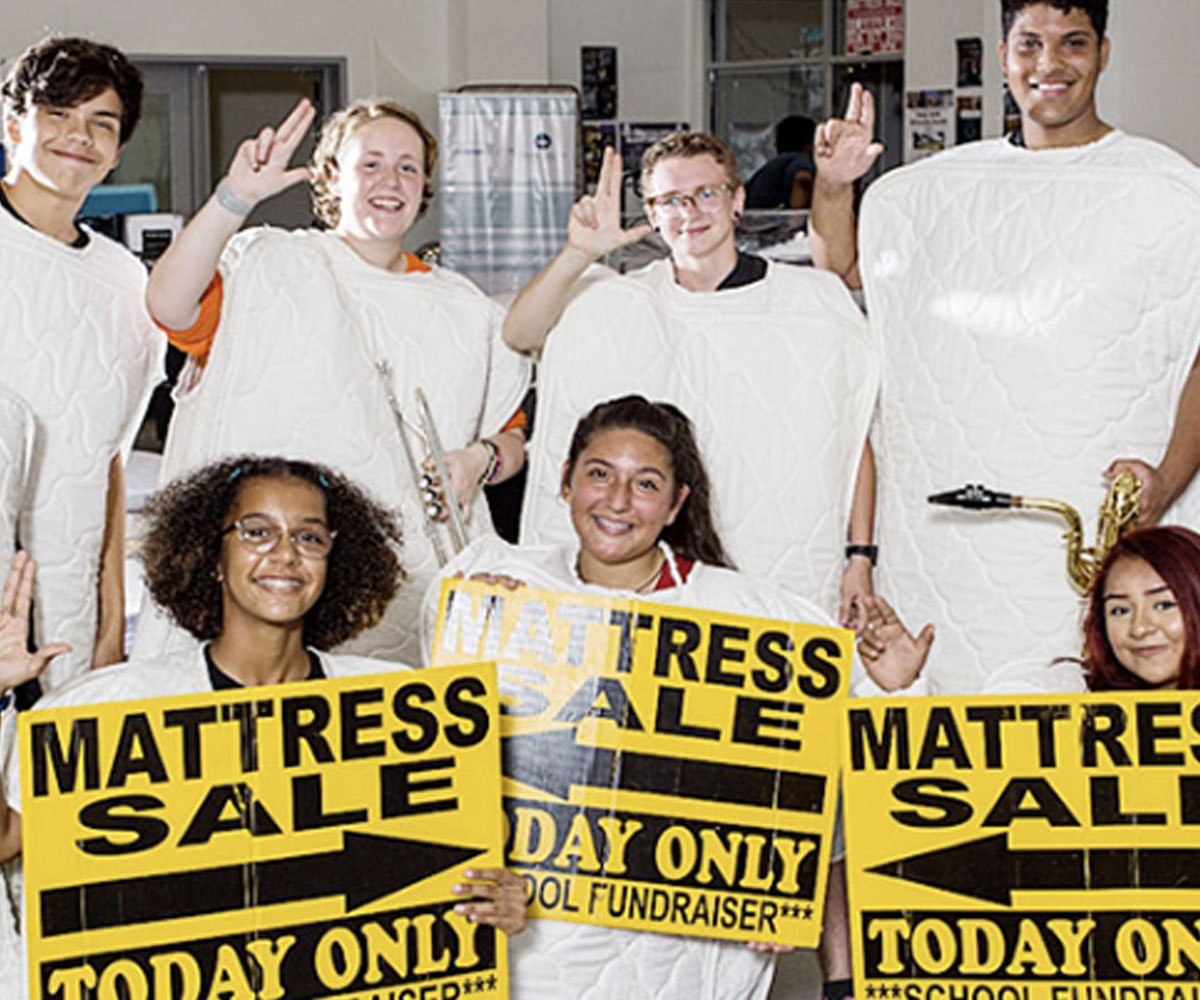 Group of Friends Showcasing a Mattress Sale