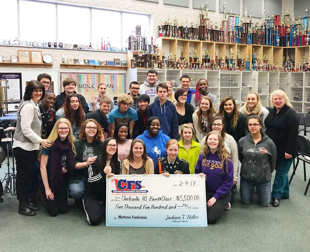Group of People Showcasing a Mattress Fundraiser Cheque