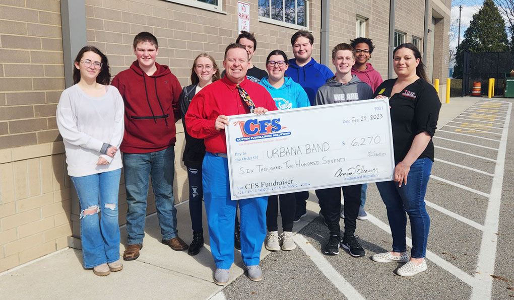 Group of People Showcasing a Mattress Fundraiser Cheque